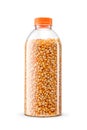 Plastic bottle with raw corn kernels for popcorn isolated on white Royalty Free Stock Photo