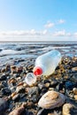 Plastic pet bottle on a stony beach Royalty Free Stock Photo