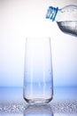 Plastic bottle with water over empty drinking glass Royalty Free Stock Photo