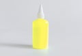 Plastic bottle with yellow liquid glue Royalty Free Stock Photo