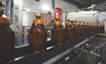 Plastic bottles for beer or carbonated beverage moving on conveyor. Shallow DOF. Selective focus. Royalty Free Stock Photo