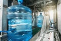 Plastic bottles with clean drinking water in factory on conveyor belt in blurred motion Royalty Free Stock Photo