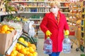 The woman in the supermarket carries two five-liter water bottle