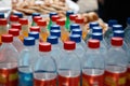 Plastic bottles with drinks and colorful lids Royalty Free Stock Photo