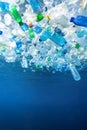 Plastic bottles floating underwater highlight ocean pollution crisis Royalty Free Stock Photo
