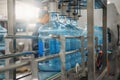 Plastic bottles or gallons on automated conveyor production line. Water factory