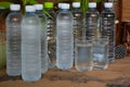 Plastic bottles and glasses of cool water Royalty Free Stock Photo