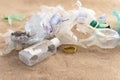 Plastic bottles lies on the beach and pollutes the sea. Spilled garbage on the beach Royalty Free Stock Photo