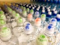 Plastic bottles with mineral water. Closeup on water bottles in raw and lines. Plastic bottles, colorful caps. Plastic bottles wit Royalty Free Stock Photo