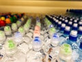 Plastic bottles with mineral water. Closeup on water bottles in raw and lines. Plastic bottles, colorful caps. Plastic bottles wit Royalty Free Stock Photo