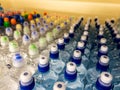 Plastic bottles with mineral water. Closeup on water bottles in raw and lines. Plastic bottles, colorful caps. Plastic bottles wit Royalty Free Stock Photo