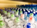 Plastic bottles with mineral water. Closeup on water bottles in raw and lines. Plastic bottles, colorful caps. Plastic bottles wit Royalty Free Stock Photo