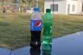 Plastic Bottles of Pepsi and 7up on nature background-These carbonated soft drinks are produced and manufactured by PepsiCo