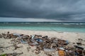 Plastic bottles, plastic bags and waste at dirty beach near ocean at the tropical island