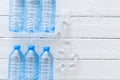 Plastic bottles with pure water and ice on white wooden background top view space for text Royalty Free Stock Photo