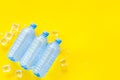 Plastic bottles with pure water and ice on yellow background top view space for text Royalty Free Stock Photo