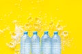 Plastic bottles with pure water and ice on yellow background top view space for text Royalty Free Stock Photo