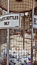 Plastic bottles recycle cage. No to plastics, save the earth! Royalty Free Stock Photo