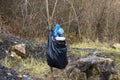 Plastic bottles in the trash in nature hanging from a branch