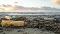 Plastic bottles discarded on pollution contaminated ocean sea coast,sunset time,environmental waste Royalty Free Stock Photo