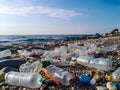 Plastic bottles and waste washed up on a beach. Micro plastic sea pollution