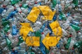 Plastic bottles with a yellow recycling symbol from above