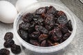 Plastic bowl with black flame raisins from Chili close up