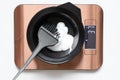 In a plastic bowl with a brush, hair keratin is weighed on a scale, hair keratin in a bowl on a scale, desktop scales