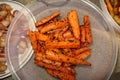 A plastic bowl of cooked carrots