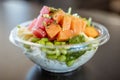 Plastic bowl tasty seafood salad with rice and edamame beans