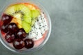 Plastic bowl yogurt smoothie with fresh fruits, Kiwi, grape and dragon fruit slice Royalty Free Stock Photo
