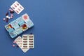 Plastic box with different pills on blue background, flat lay. Space for text Royalty Free Stock Photo