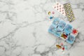 Plastic box and different pills on white marble table, flat lay. Space for text Royalty Free Stock Photo