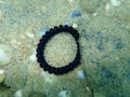 Plastic bracelet on the seabed, Aegean Sea, Greece, Halkidiki. Sea pollution
