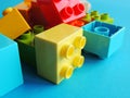 Plastic bricks, blocks toy on bright blue background. Royalty Free Stock Photo