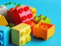 Plastic bricks, blocks toy on bright blue background. Royalty Free Stock Photo