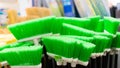 Plastic brushes for cleaning premises. Assortment of multi-colored brooms in the store. Close-up Royalty Free Stock Photo