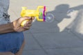 Plastic bubble makers gun in young teenage hand in outdoor area