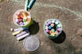 Plastic bucket with chalk for drawing on asphalt. Multi-colored crayons for children`s drawings. Drawing with chalk on asphalt.