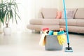 Plastic bucket with mop, sanitary items indoors.Room cleaning