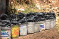 plastic buckets of coal are sold on the street of the poorest region of Africa