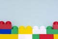 Plastic building blocks on a light blue background. Children`s educational toys. Children`s construction kit Royalty Free Stock Photo