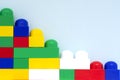 Plastic building blocks on a light blue background. Children`s educational toys. Children`s construction kit Royalty Free Stock Photo