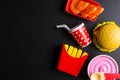 Plastic burger, French fries Fast food on black background. Children's toy. Concept of harmful artificial food. Plastic. Not Royalty Free Stock Photo