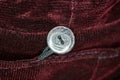 plastic button on dark pink clothing fabric Royalty Free Stock Photo