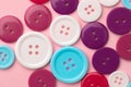 Plastic buttons on pink pastel background top view Royalty Free Stock Photo
