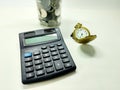 Coins in a jar with a watch and calculator, reflecting retirement funds, financial security, and careful planning Royalty Free Stock Photo