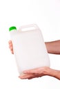 Plastic canister in hand on white background Royalty Free Stock Photo