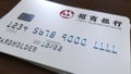 Plastic card with logo of China Merchants Bank. Editorial conceptual 3D rendering