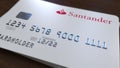 Plastic card with logo of Santander Bank. Editorial conceptual 3D rendering